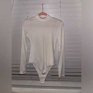 white turtle neck body suit
